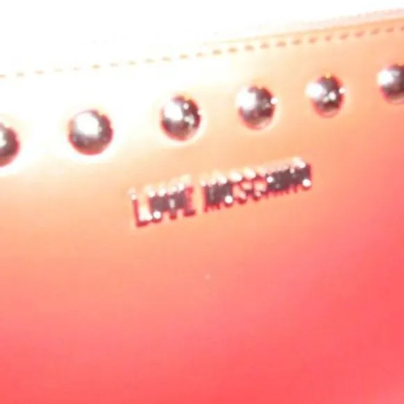 AMAZING, NWT, Moschino, true red leather, retro, clutch or cosmetic bag with chrome studs, a zip top closure, an XL engraved chrome zipper fob, and polished chrome hardware